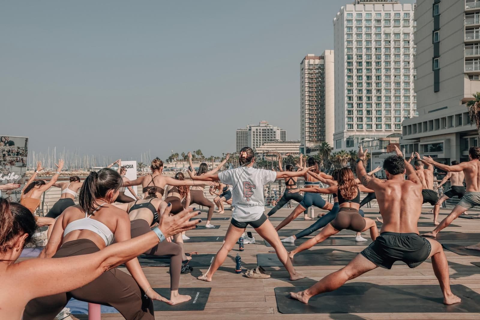 A large BINENFIT group class on the Tel Aviv beach plaza